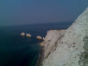 a white cliff next to the ocean