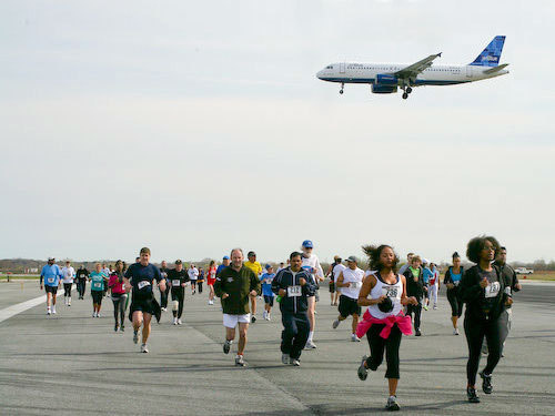 a group of people running on a runway