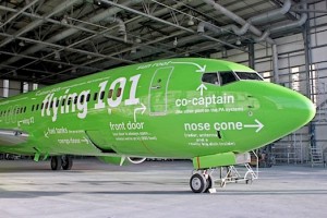 a green airplane in a hangar