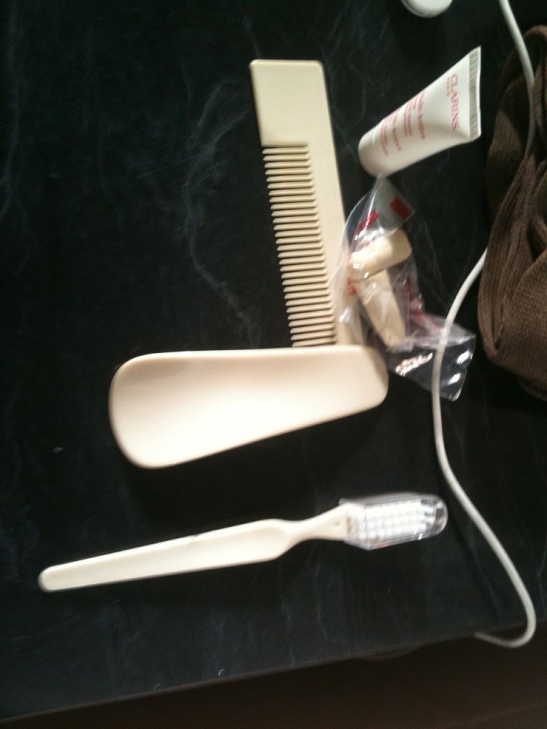 a comb and toothbrush on a black surface