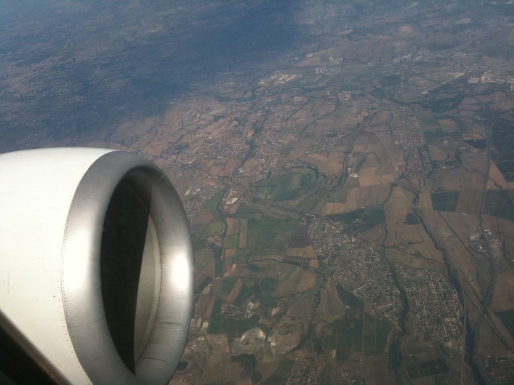 an airplane wing with a view of the earth from the sky