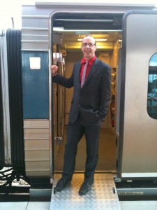 a man in a suit standing in a train