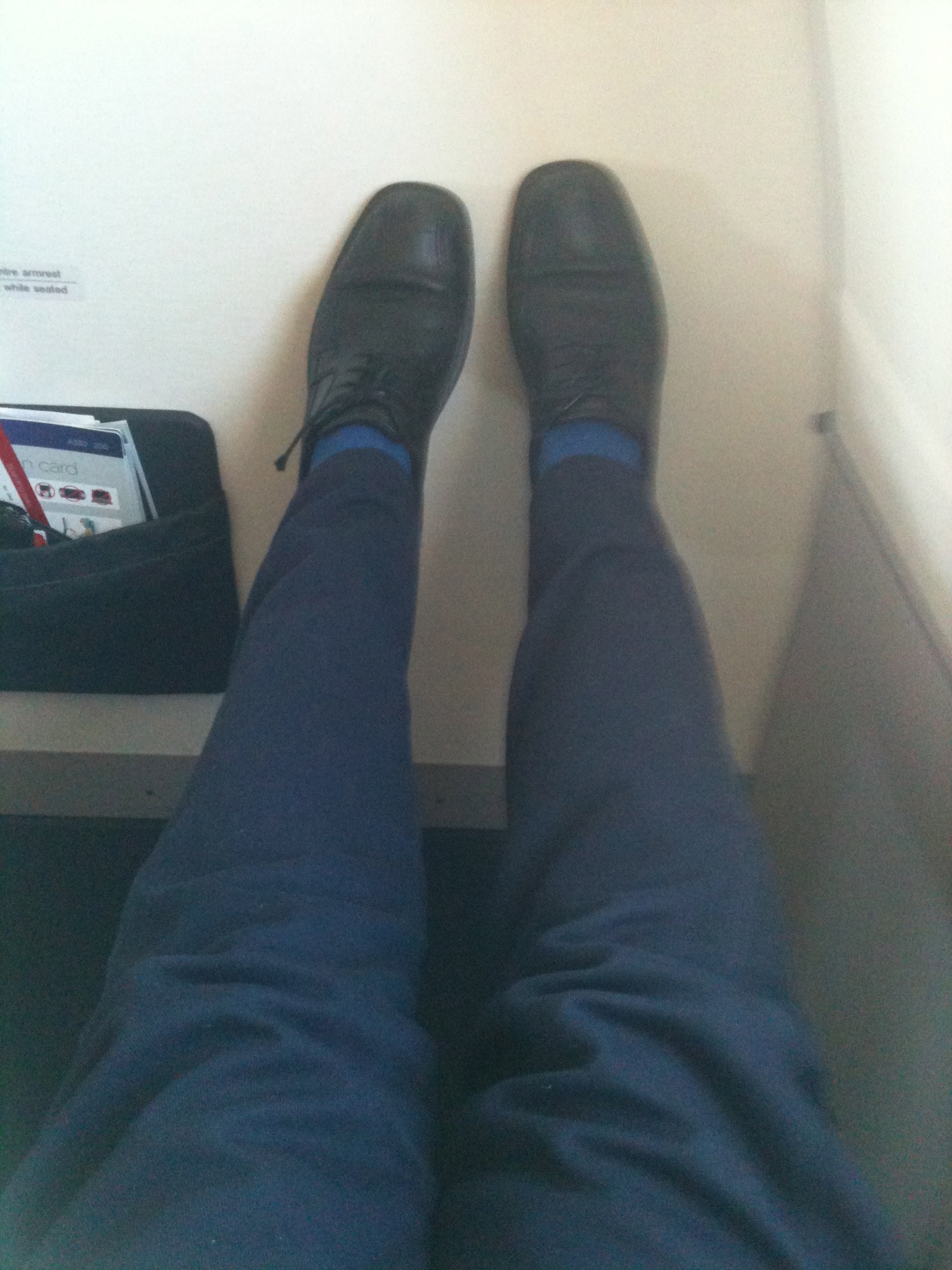 a person's legs and feet in blue pants