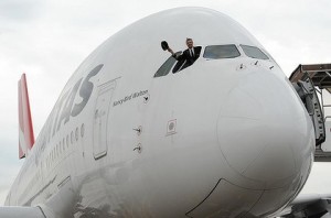 a man in a suit standing in the cockpit of an airplane