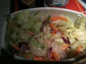a bowl of salad with lettuce and carrots
