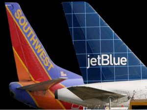 close-up of airplanes with blue and red tail fins