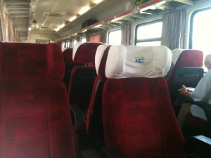 a group of red seats on a train