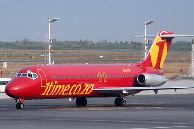 a red and yellow airplane on a runway