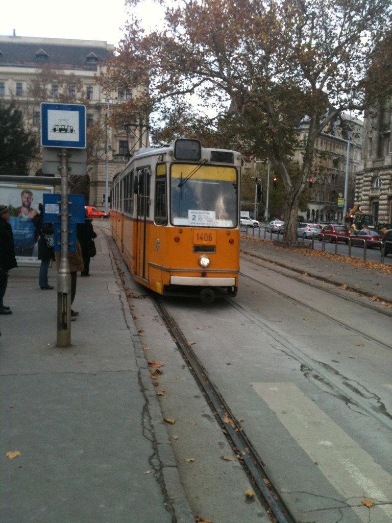 a yellow trolley on a street