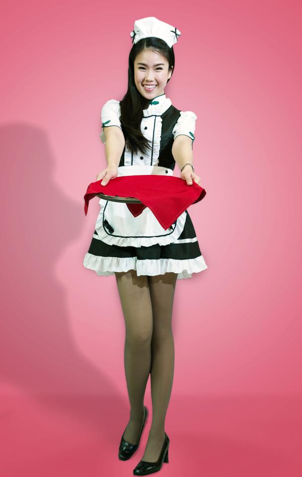 a woman in a maid outfit holding a tray