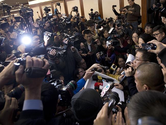 A spoke person wears glasses from the Malaysia Airlines, right, speaks to the media in Beijing  (AP Photo/Andy Wong)