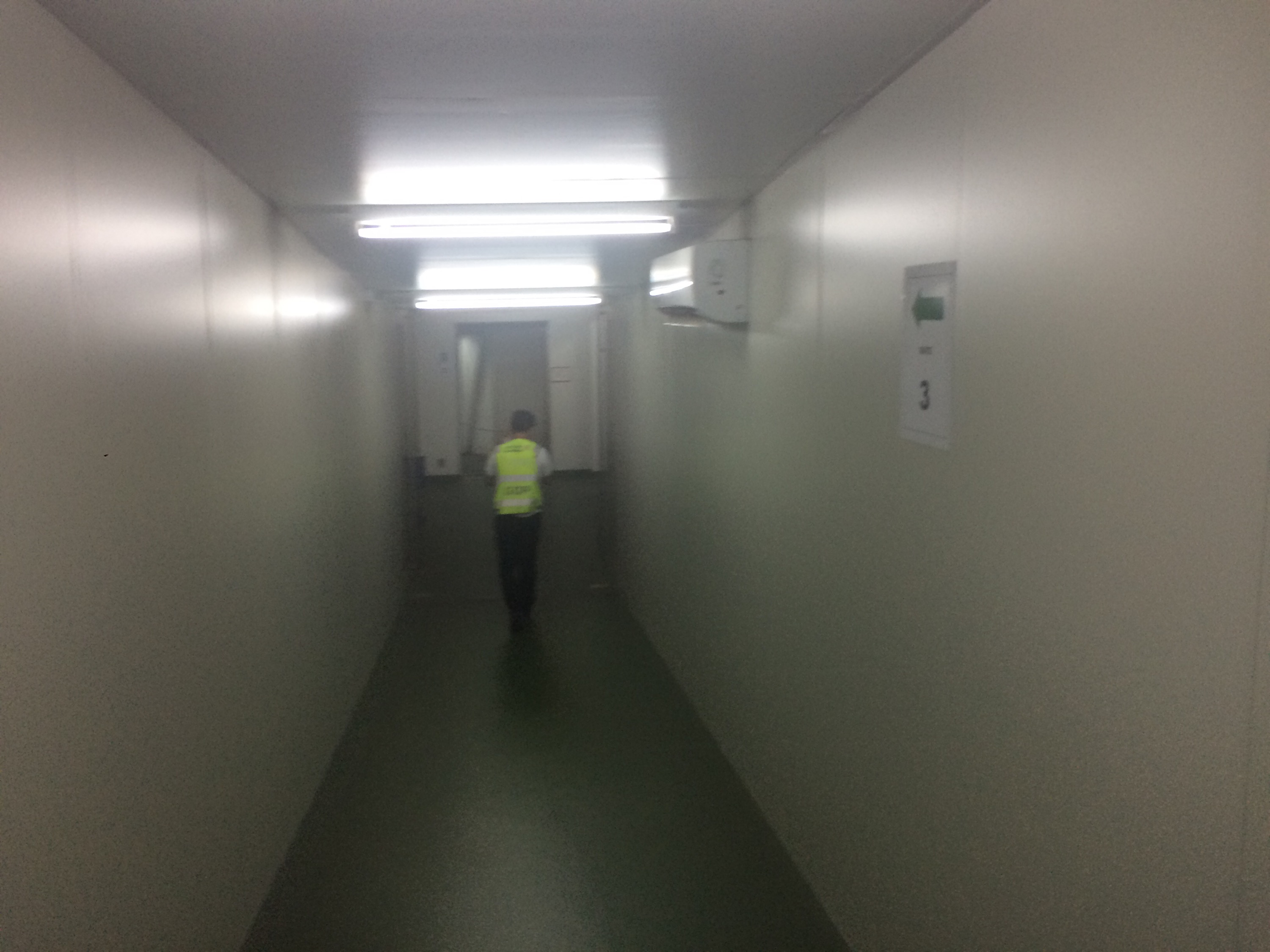 a man walking in a hallway
