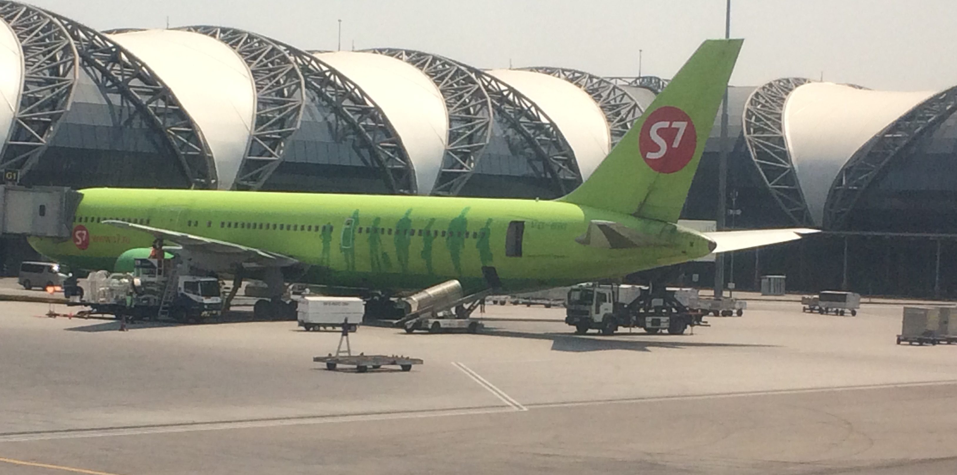 a green airplane at an airport