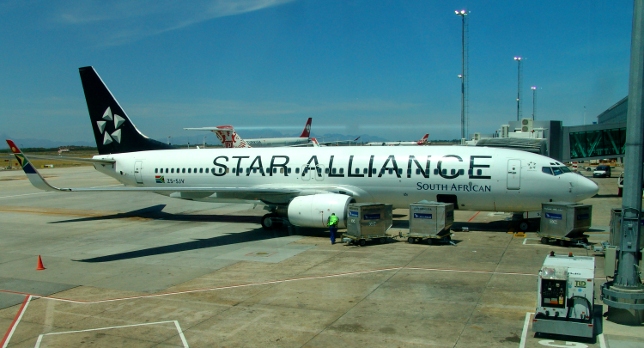 a large white airplane with black writing on it