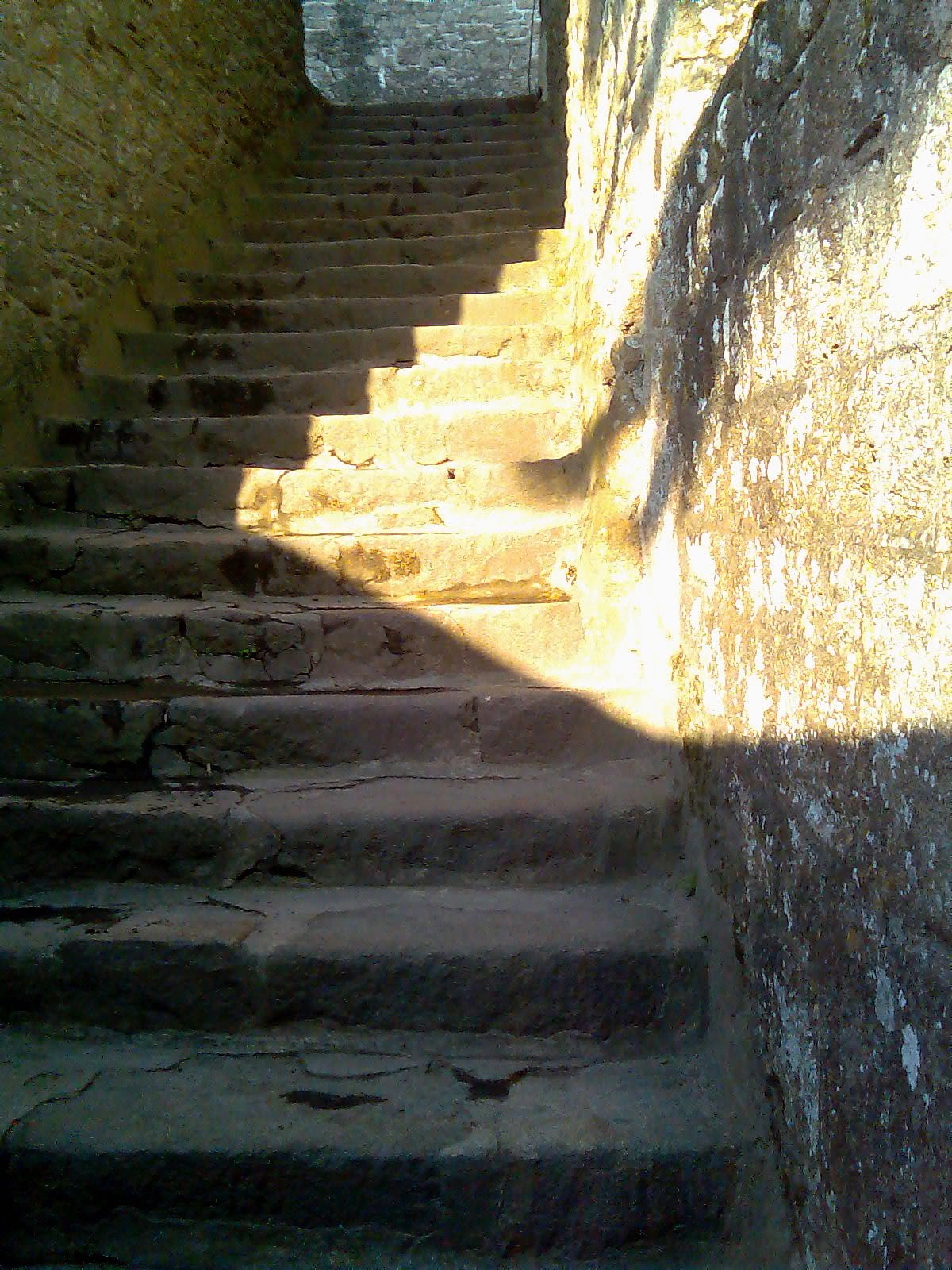 a stone stairs with sunlight coming down