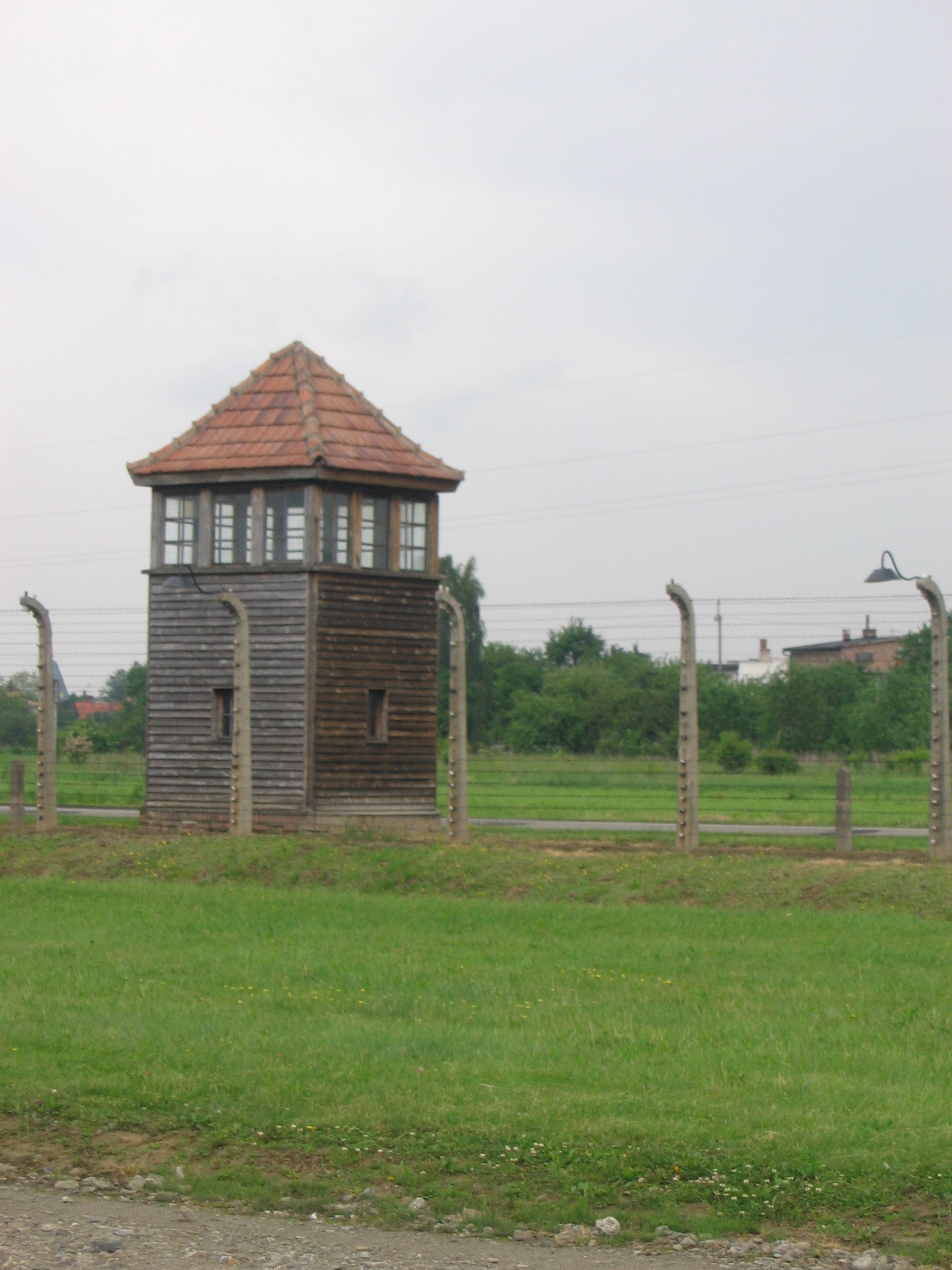 a tower next to barbed wire