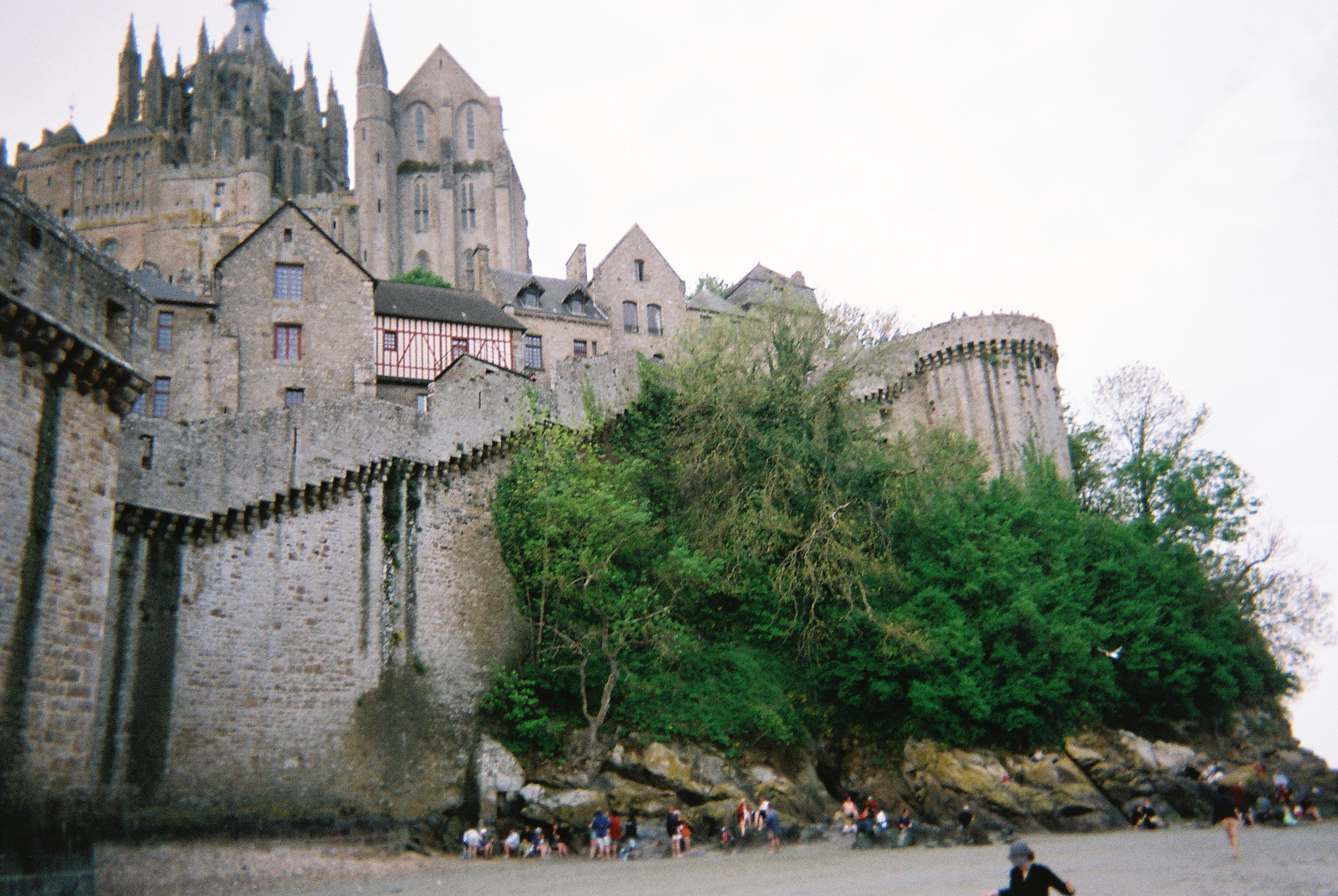 a castle with a group of people on a beach