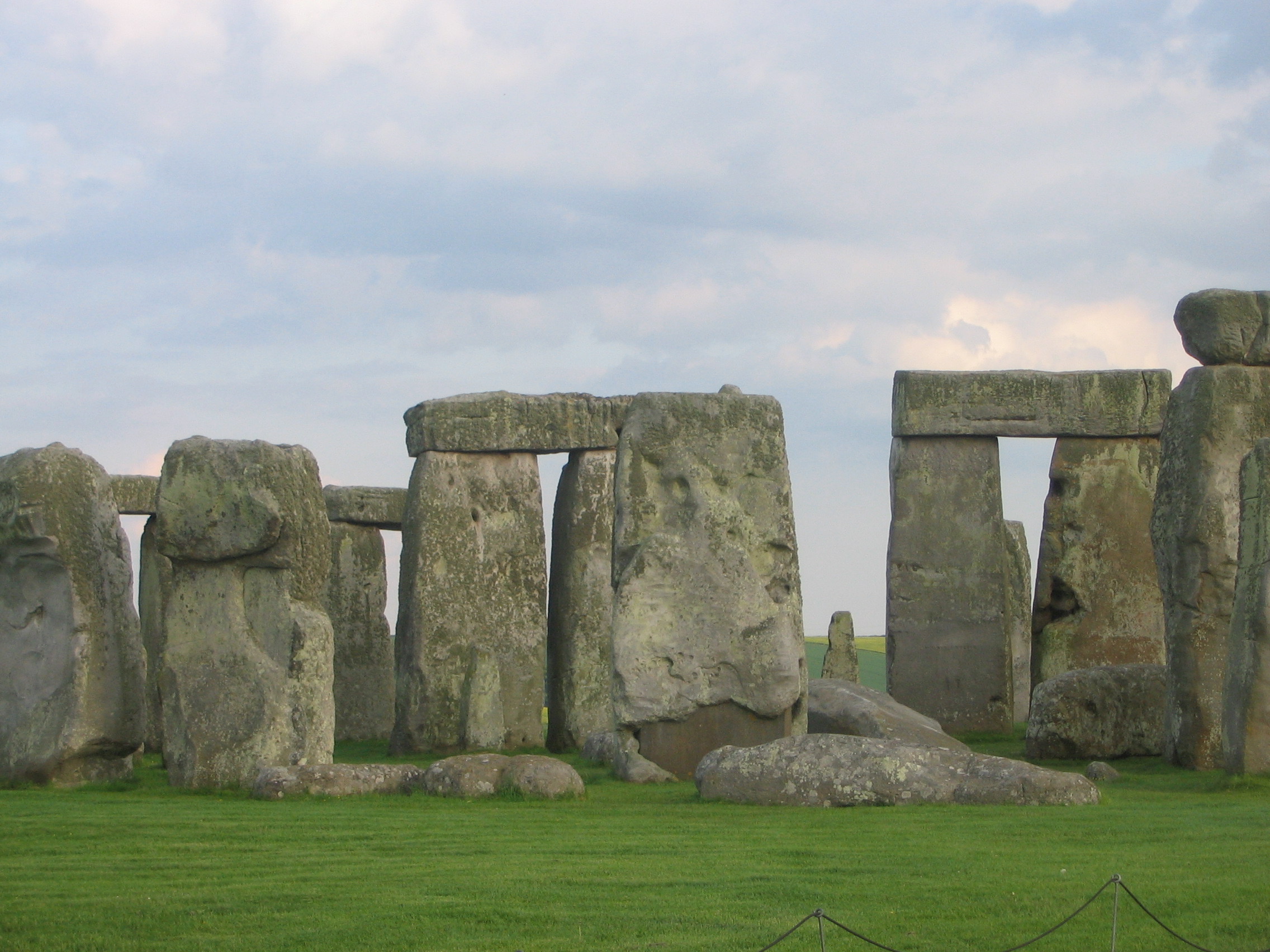 stone stonehenge in a grassy field with Stonehenge in the background