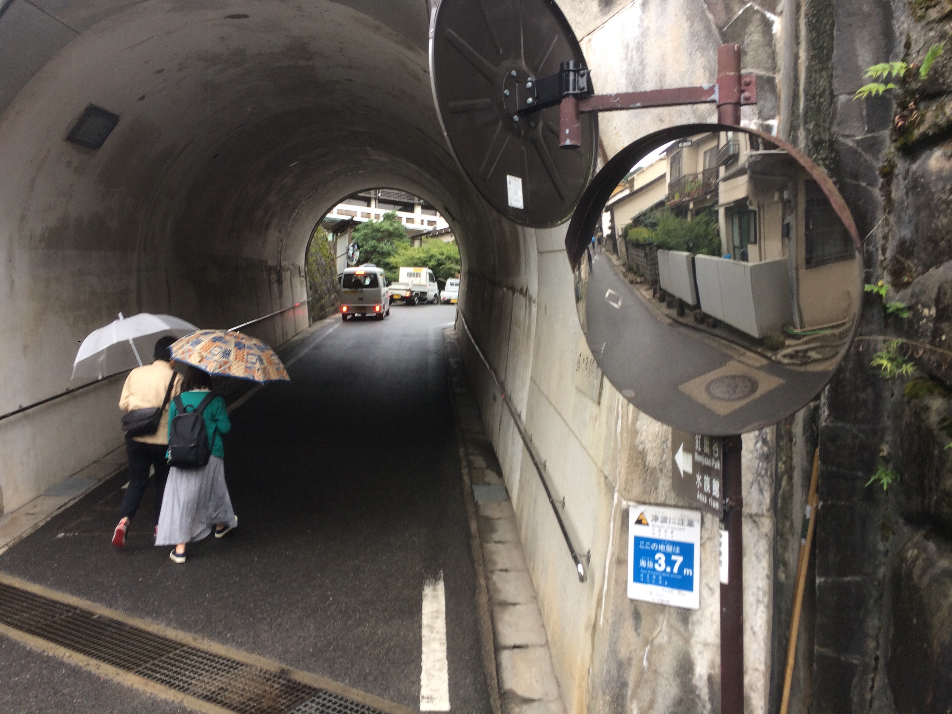 a couple of people under a tunnel with a couple of satellite mirrors