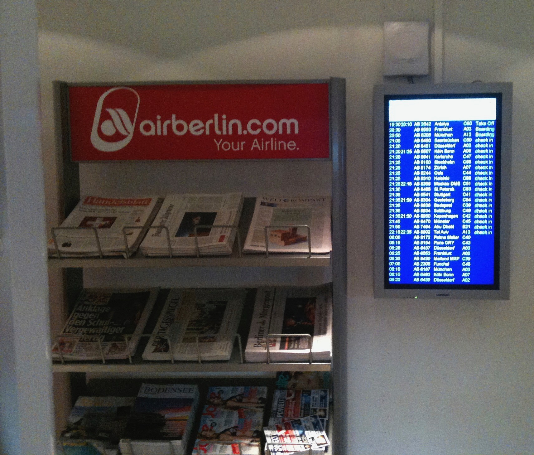 a display of newspapers and a screen