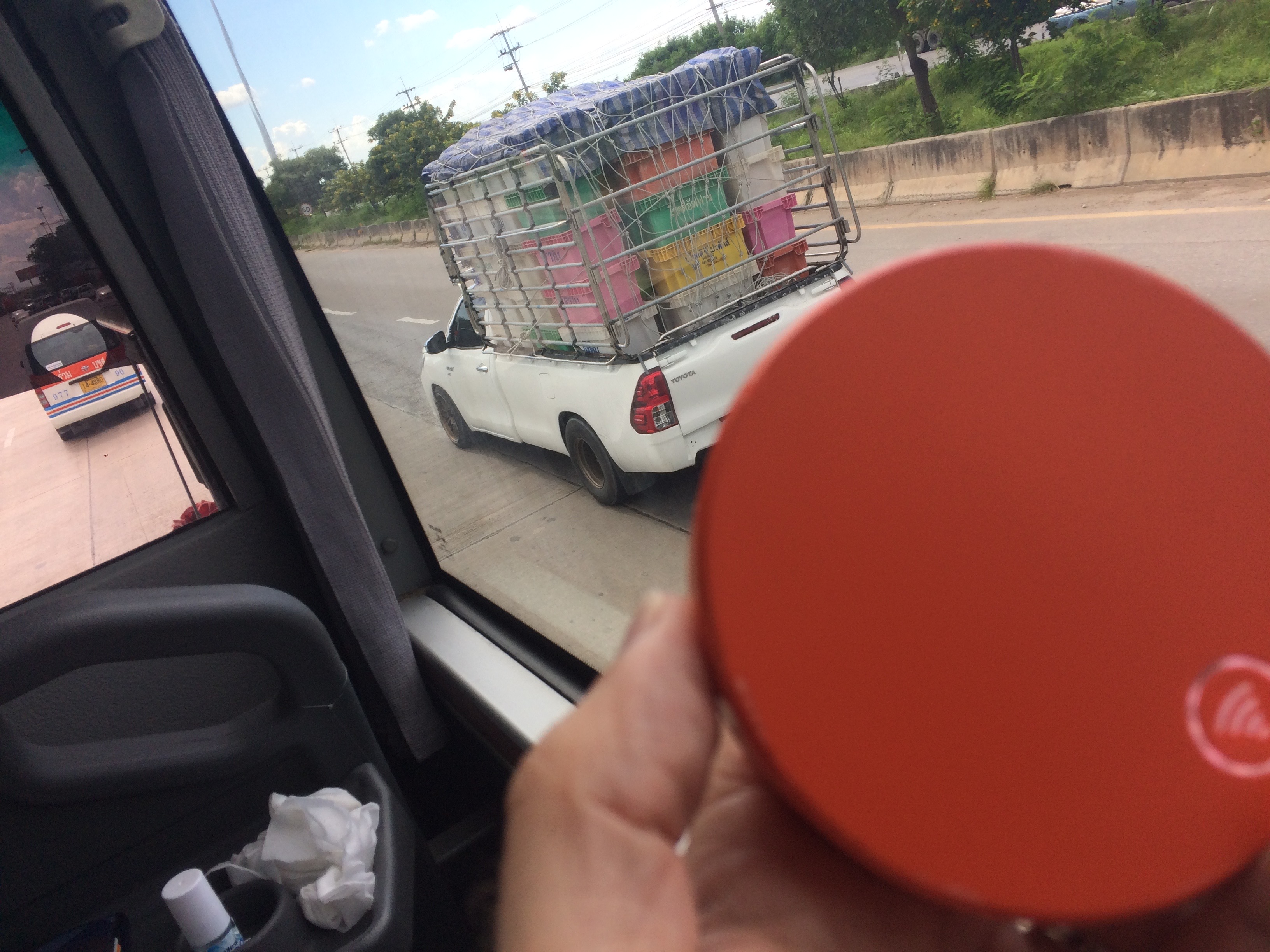 a person holding a container on a truck