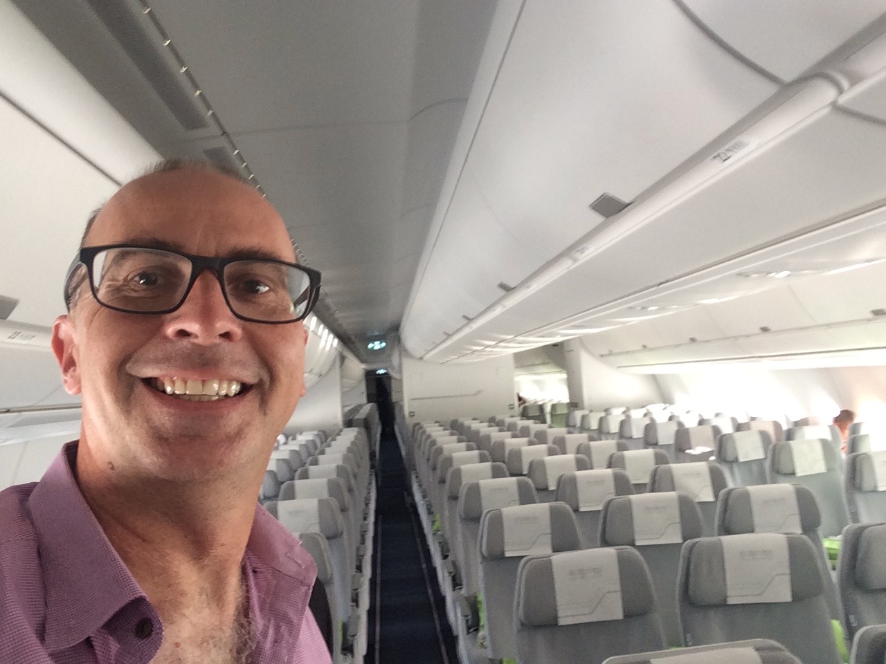 a man taking a selfie in an airplane