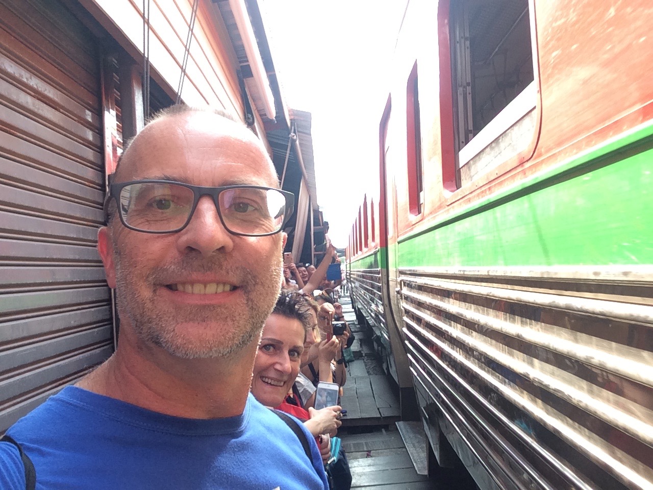 a man taking a selfie with a train