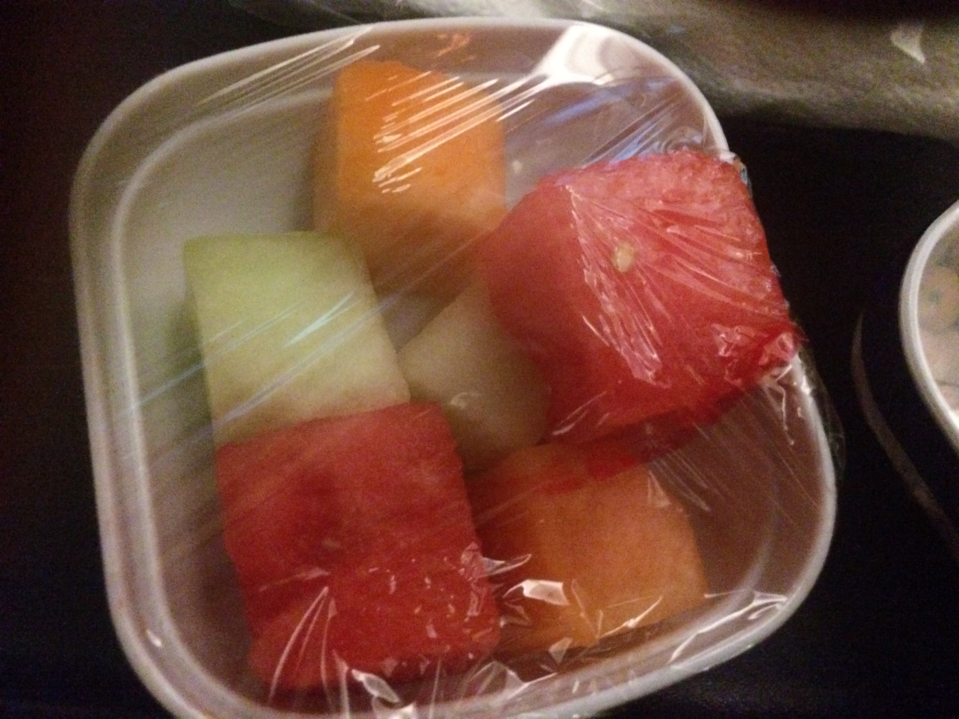 a plastic wrap around a container of fruit