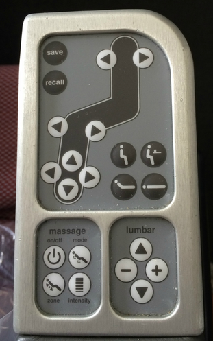 a grey remote control with buttons and a black line
