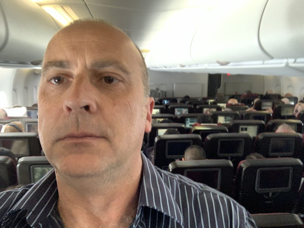 a man taking a selfie in an airplane