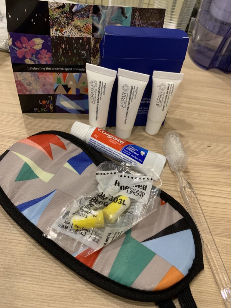a bag with toothpaste and toothbrush on a table
