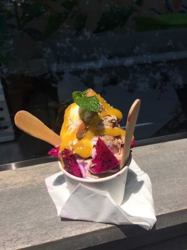a cup of ice cream with fruit on top