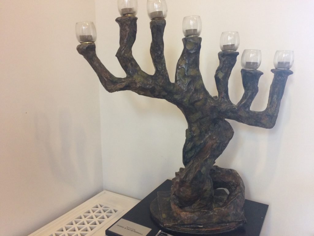 a statue of a tree with candles