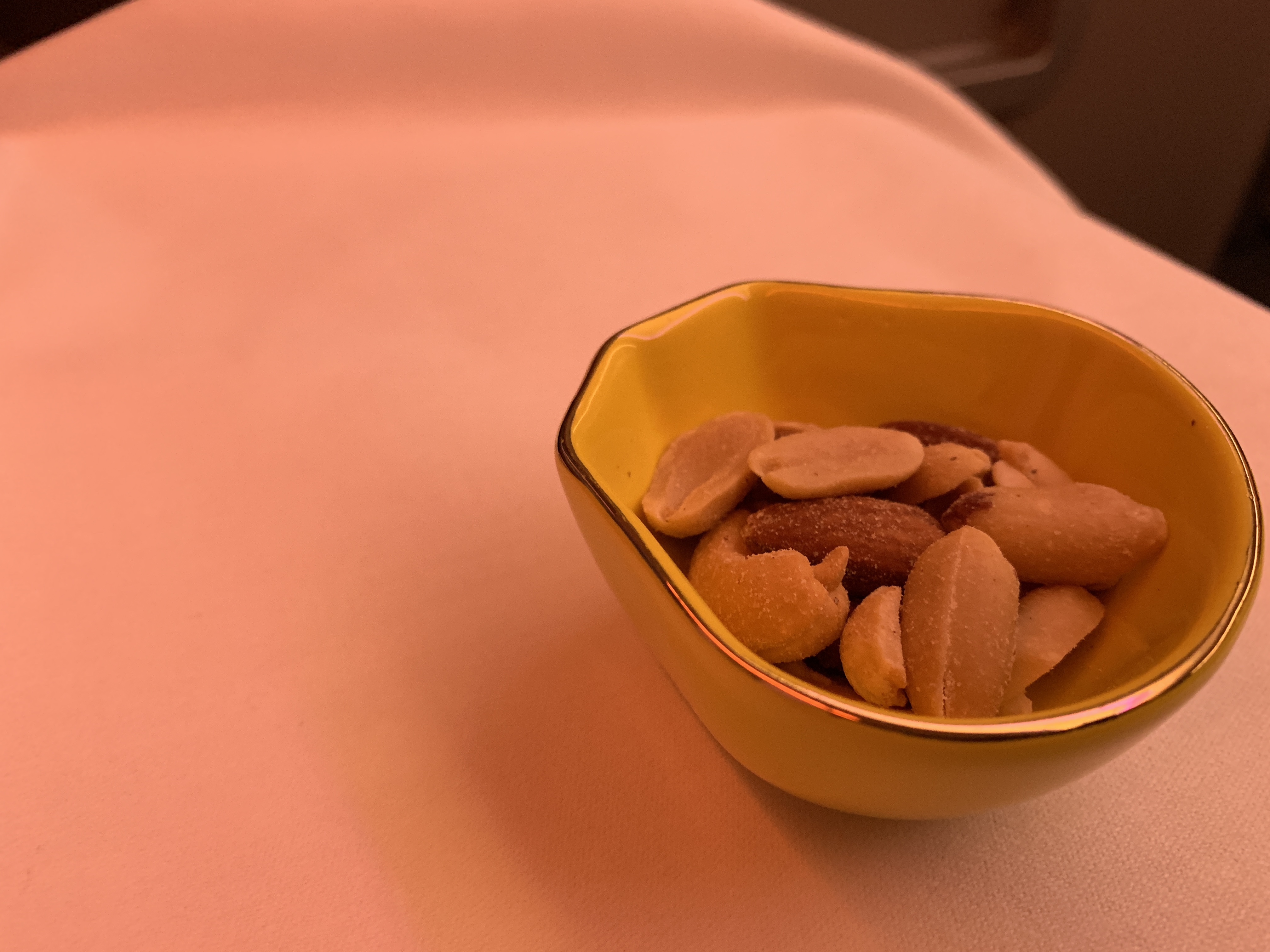 a bowl of nuts on a white surface