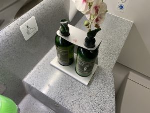 two bottles with flowers on a counter