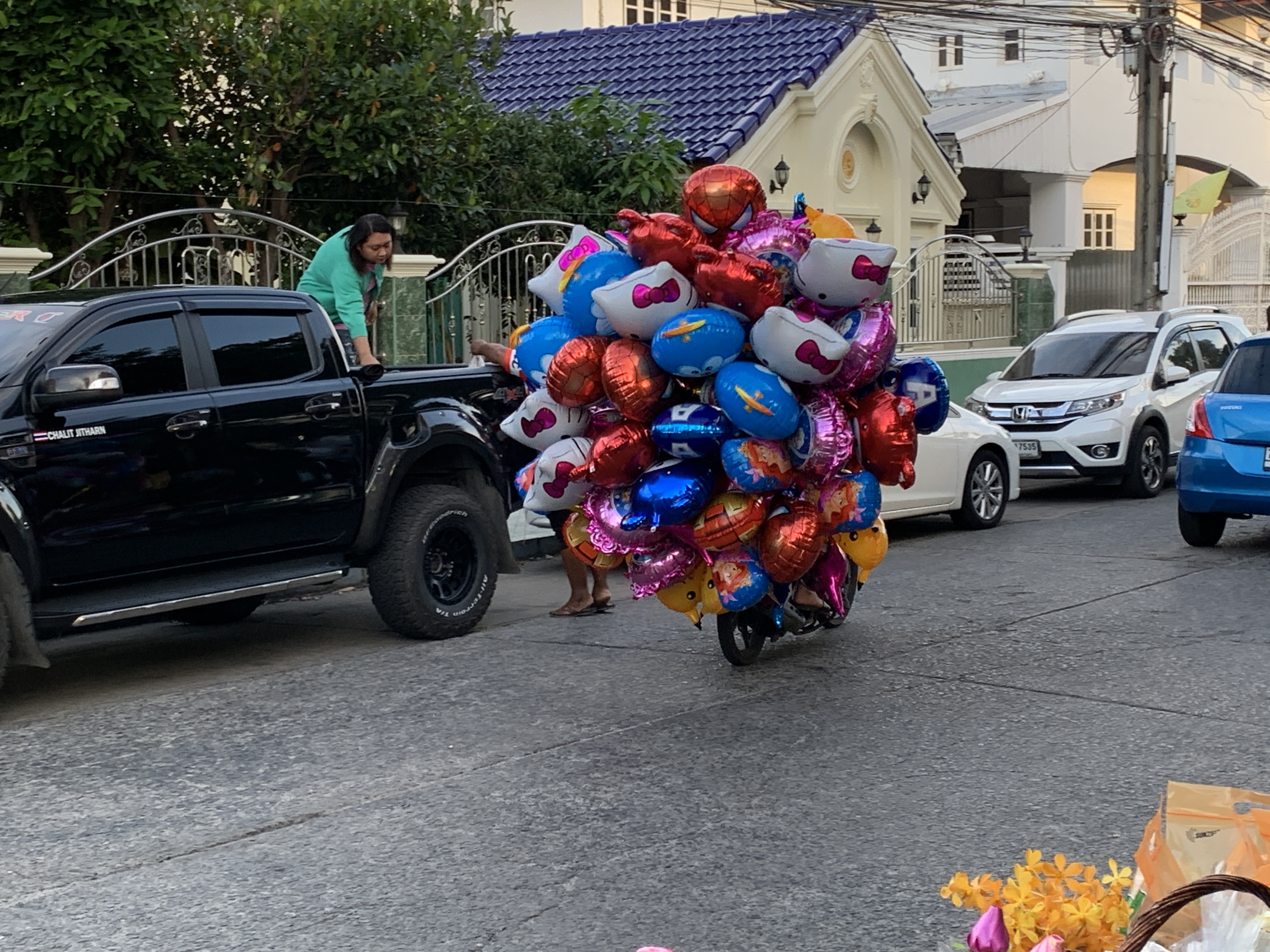 a scooter with balloons on the road