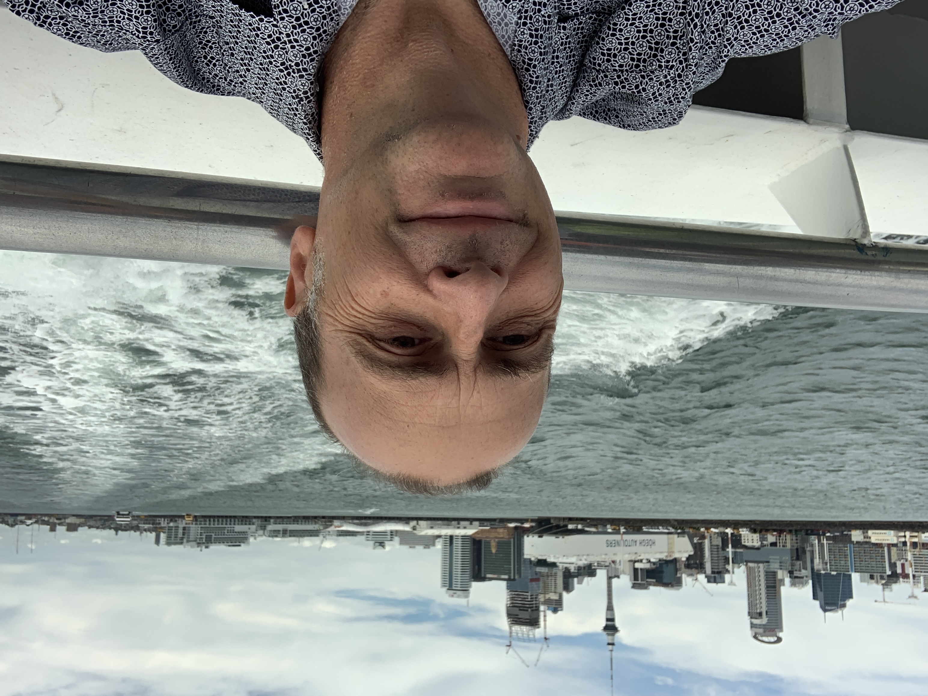 a man taking a selfie on a boat