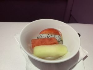 a bowl of fruit on a napkin