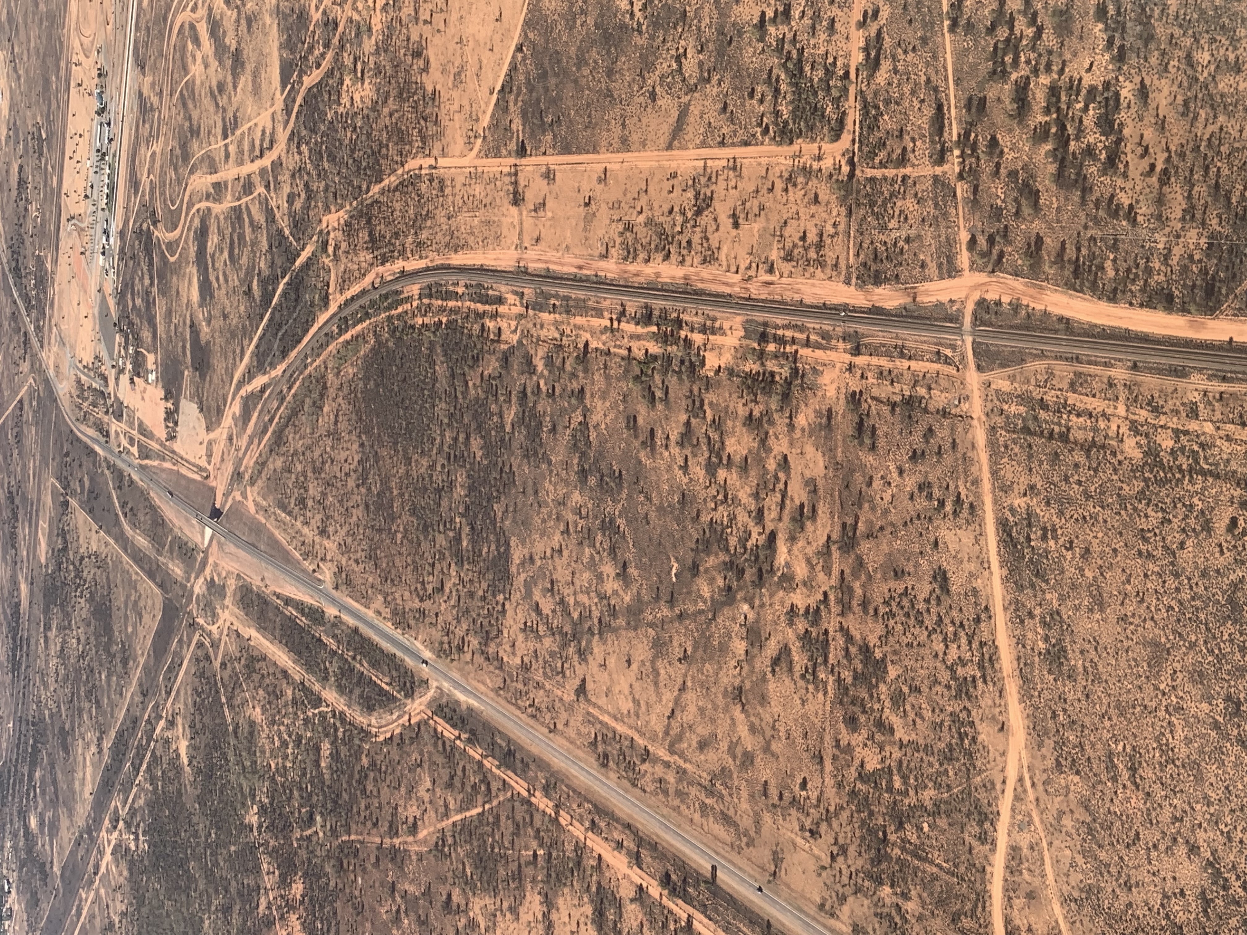 a road in the desert with Nazca Lines in the background