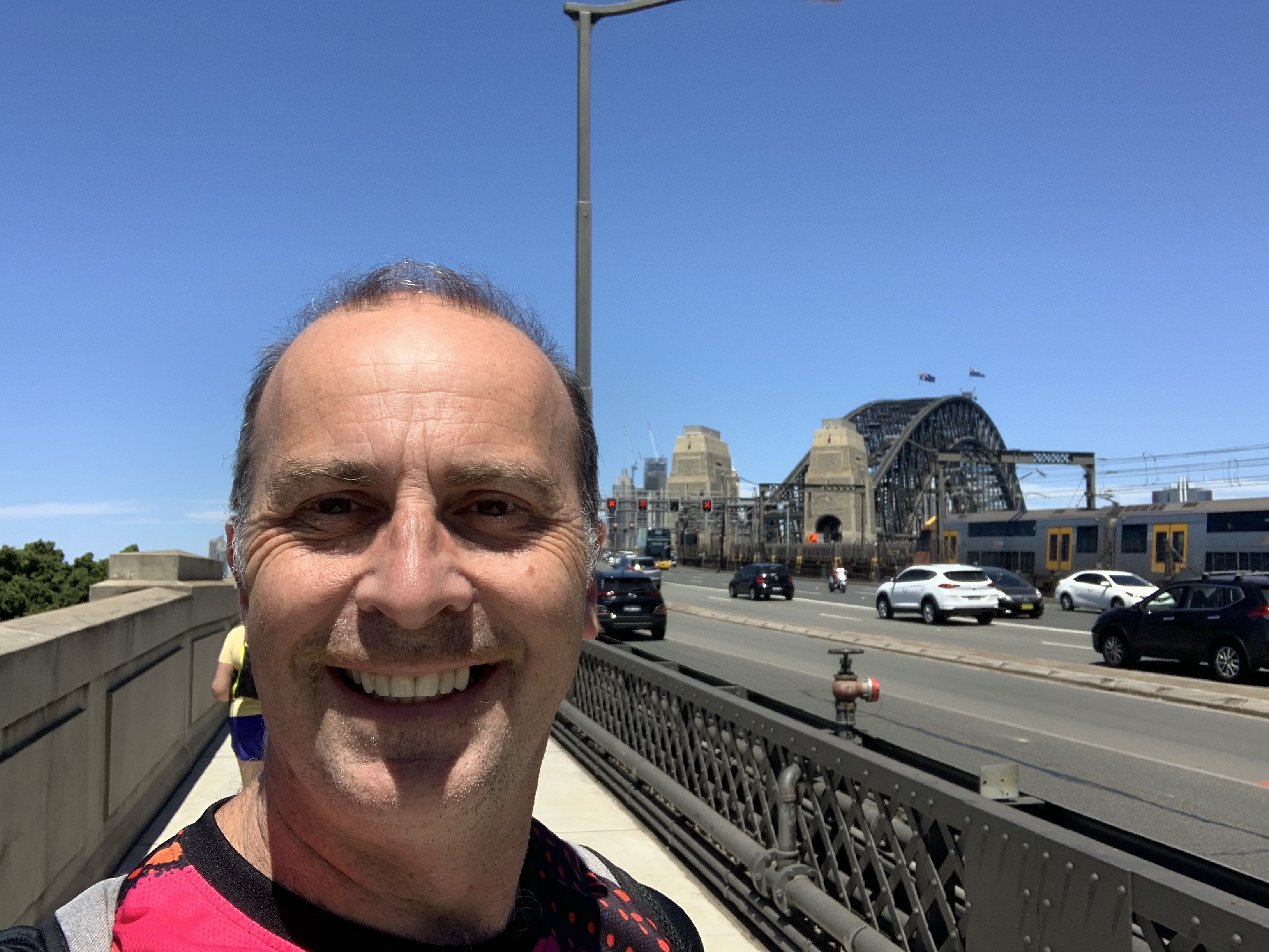 a man taking a selfie on a bridge