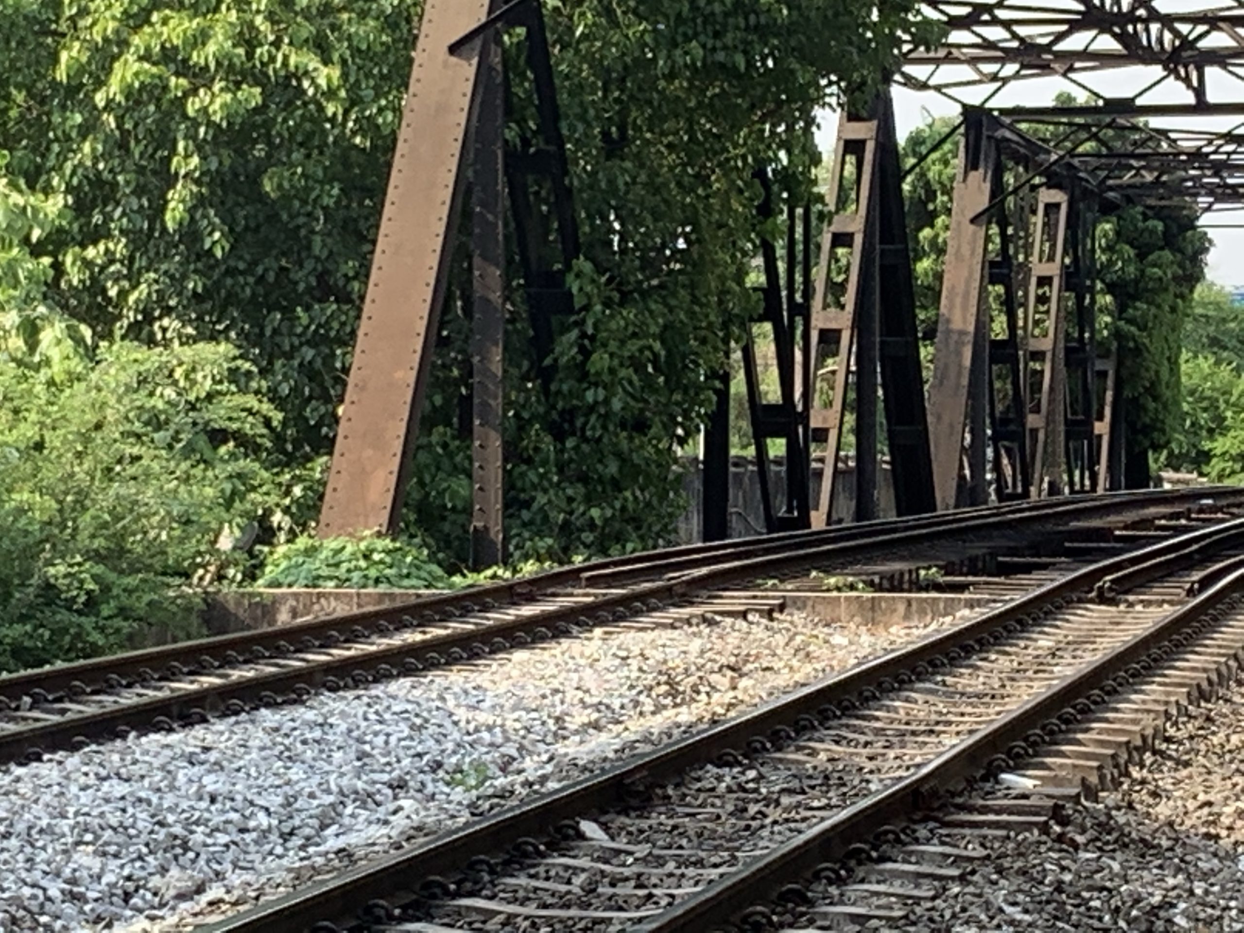 a train tracks next to a bridge