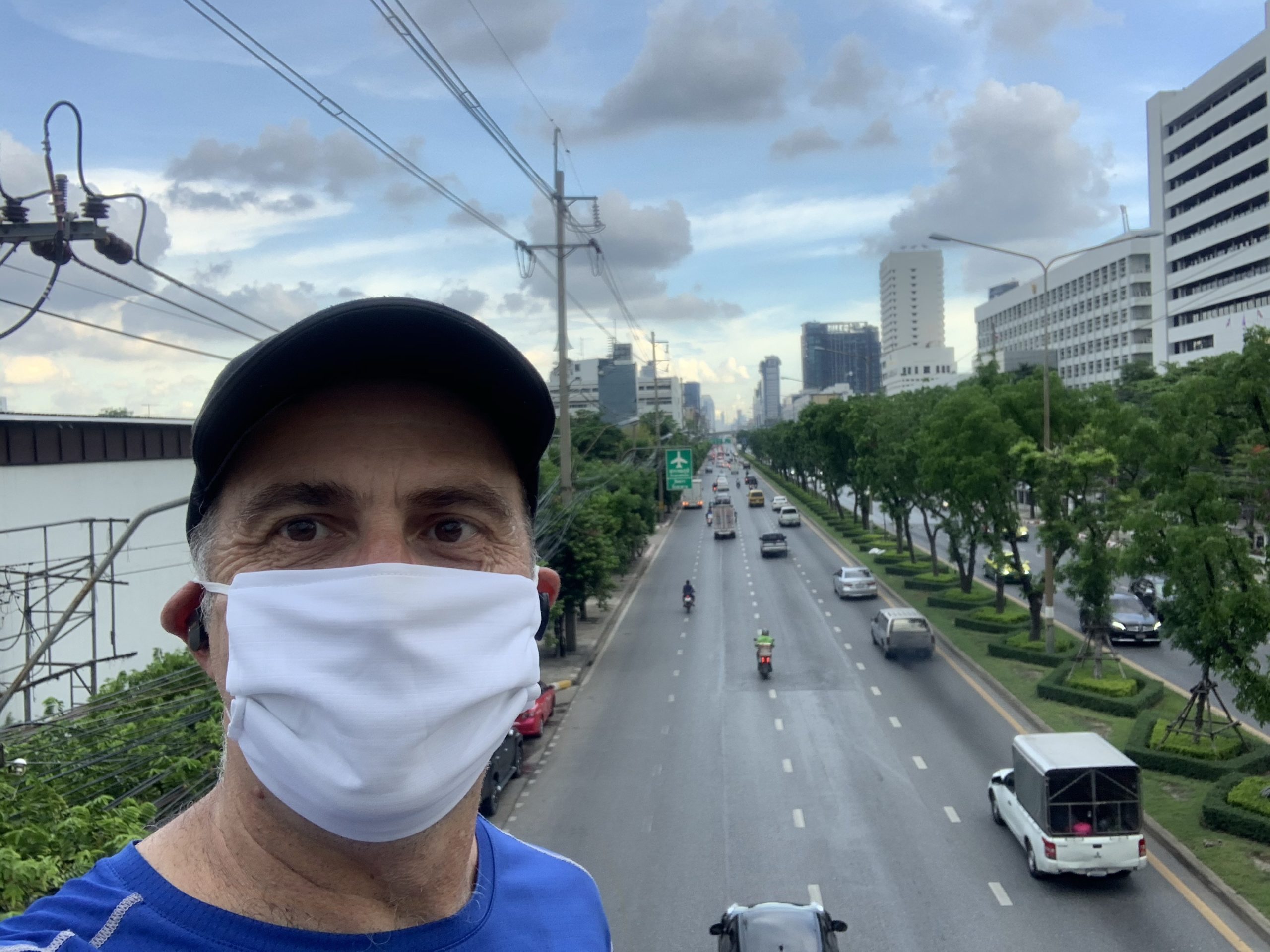 a man wearing a white face mask on a street