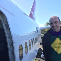 a man standing next to an airplane