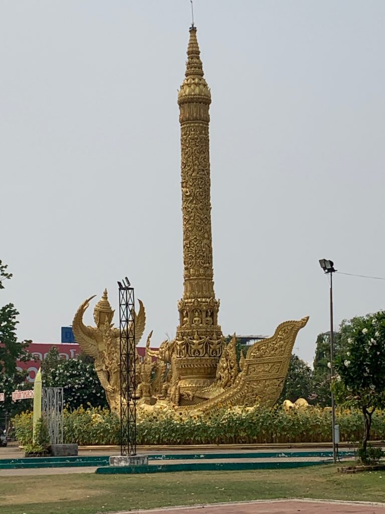 a gold statue with a tall tower