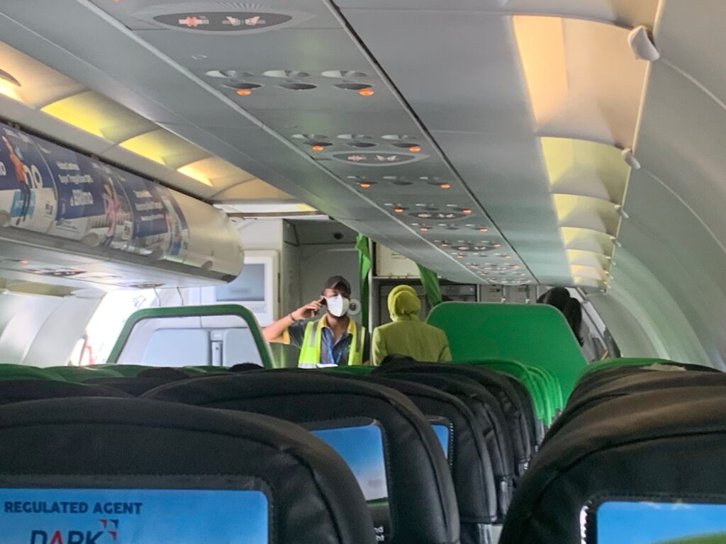a person in a mask on an airplane