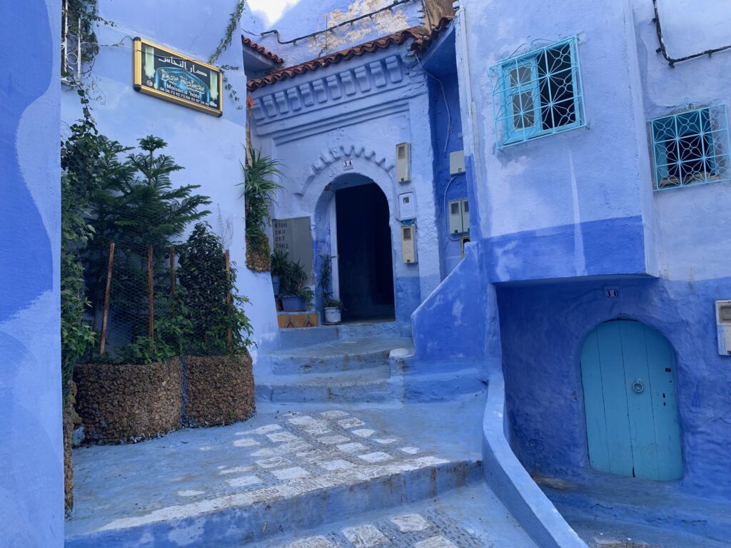 a blue building with a door and stairs