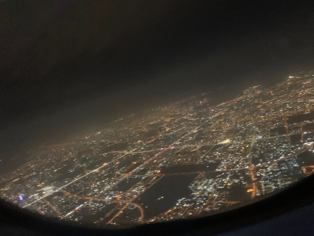 a view of a city at night from an airplane window