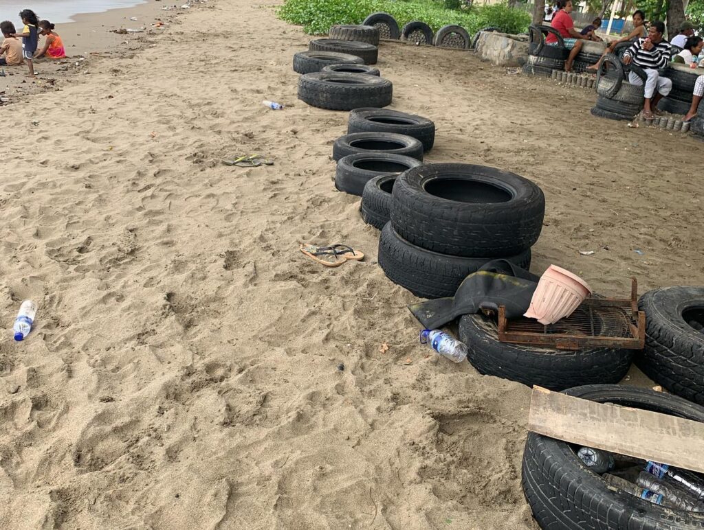 a row of tires on a beach