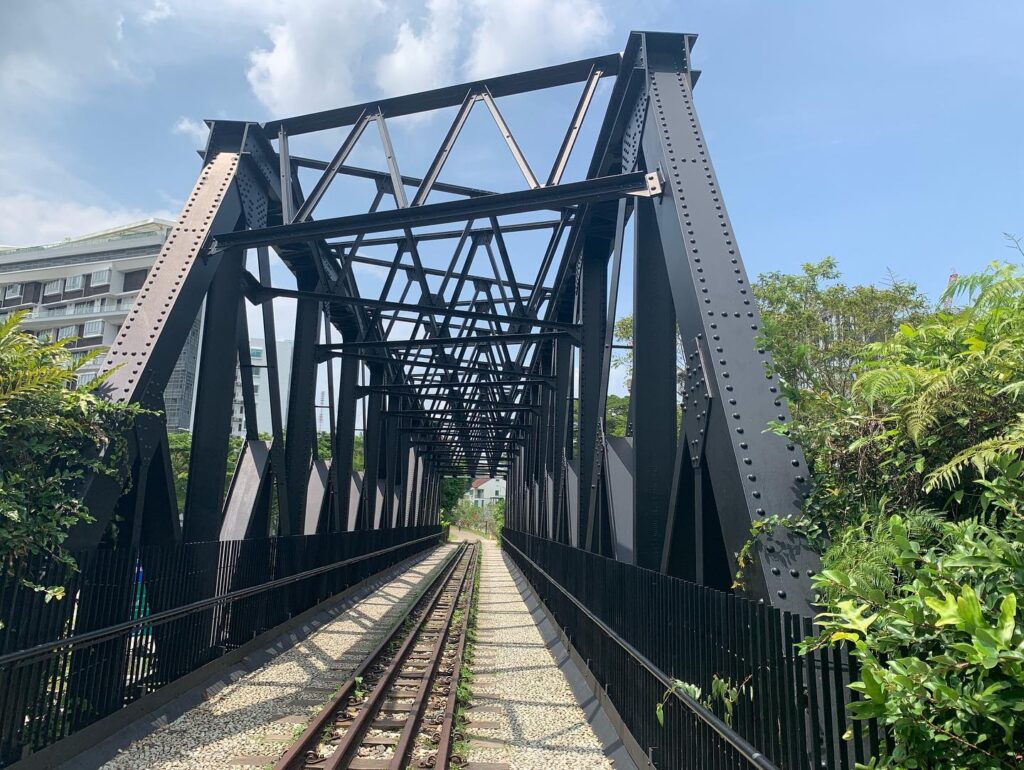 a train tracks under a bridge