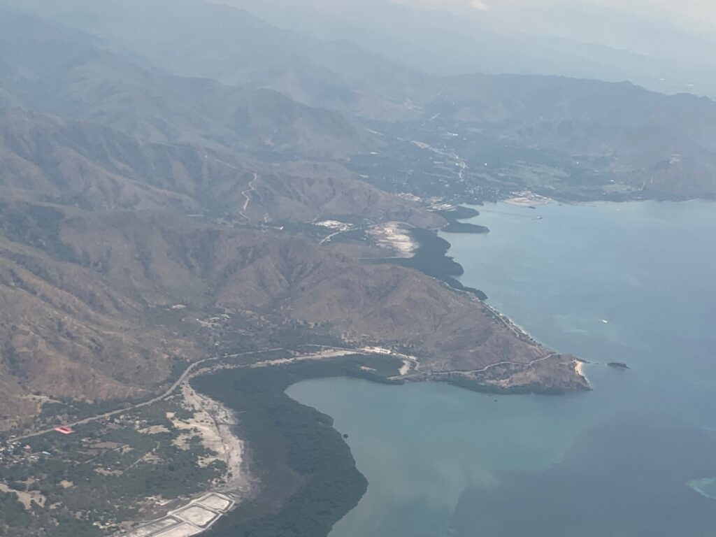 an aerial view of a body of water and mountains